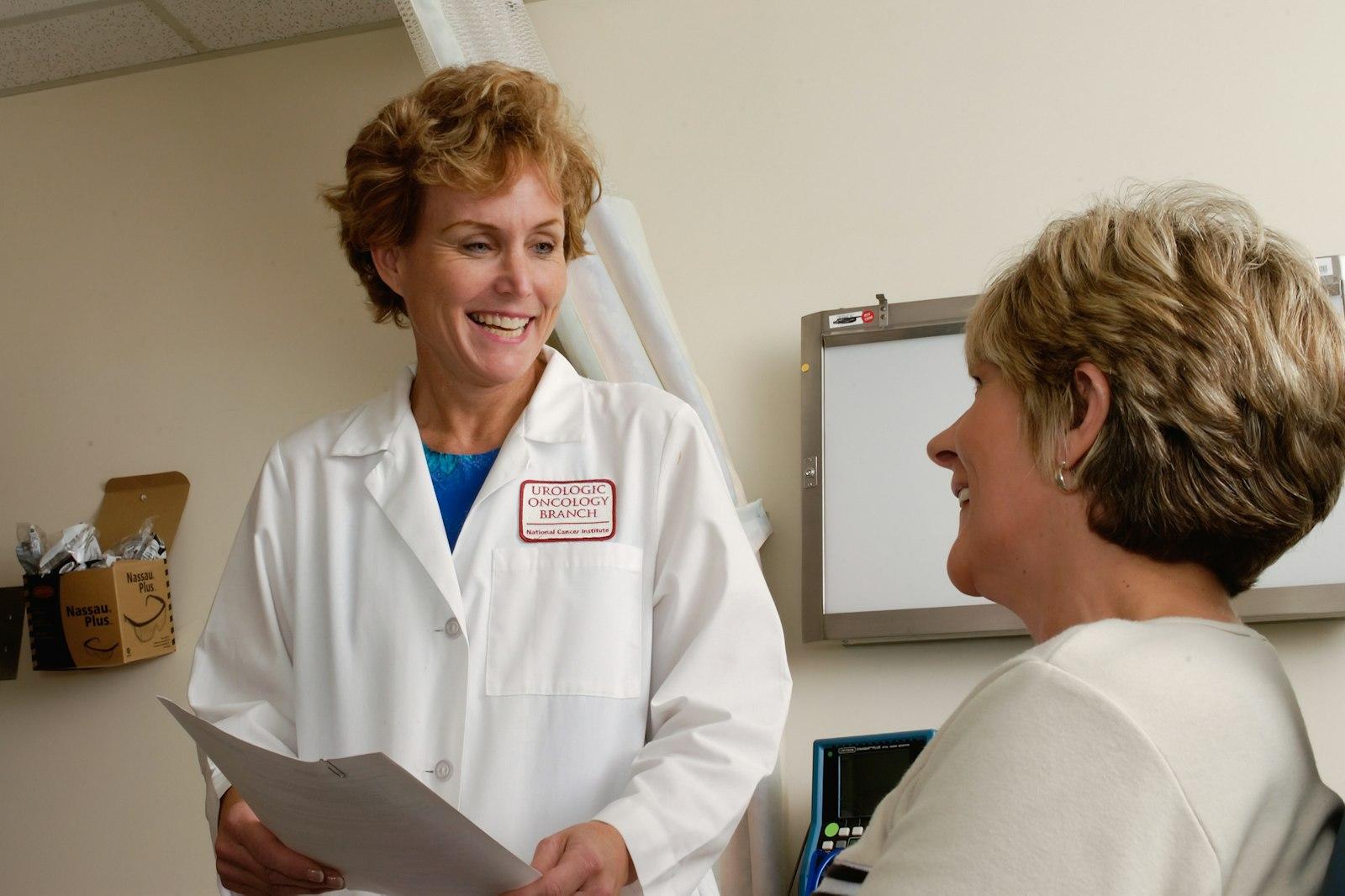 Senior compliance director reviewing customized safety binders with a practice manager in Healthcare Covered Entities